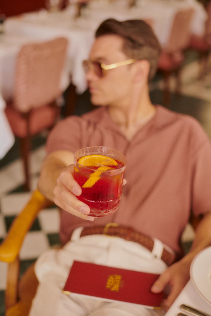 Man relaxing with a fresh negroni