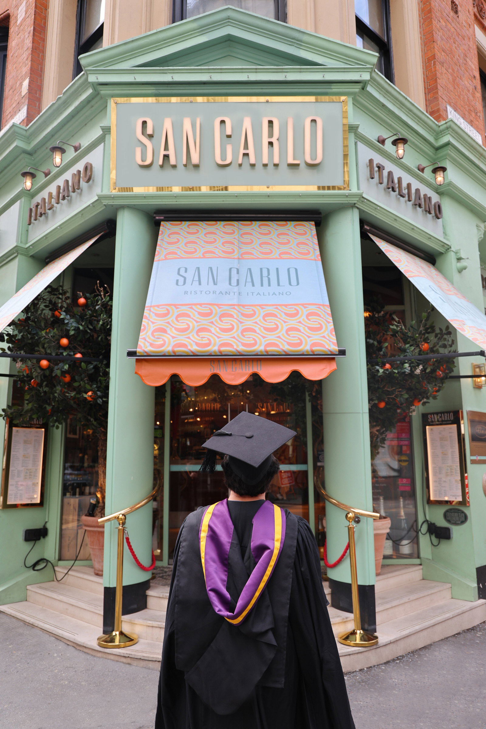 Stood outside San Carlo in graduation gown