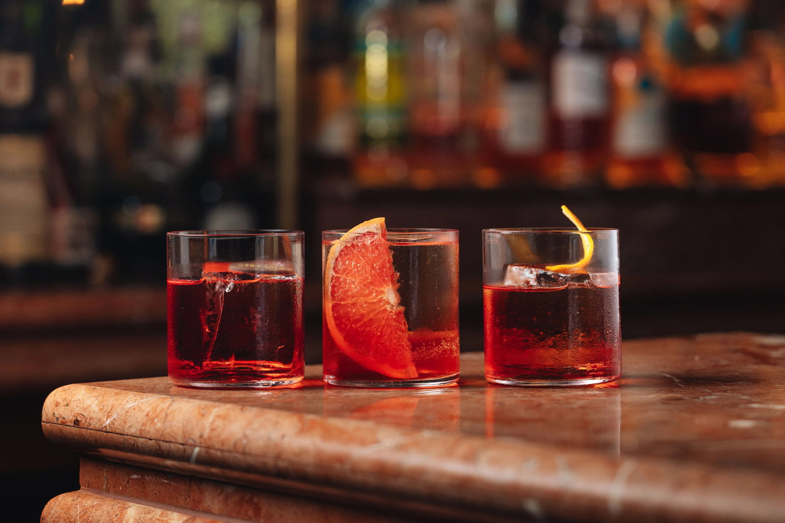 Each Negroni Lined up in a stunning bar